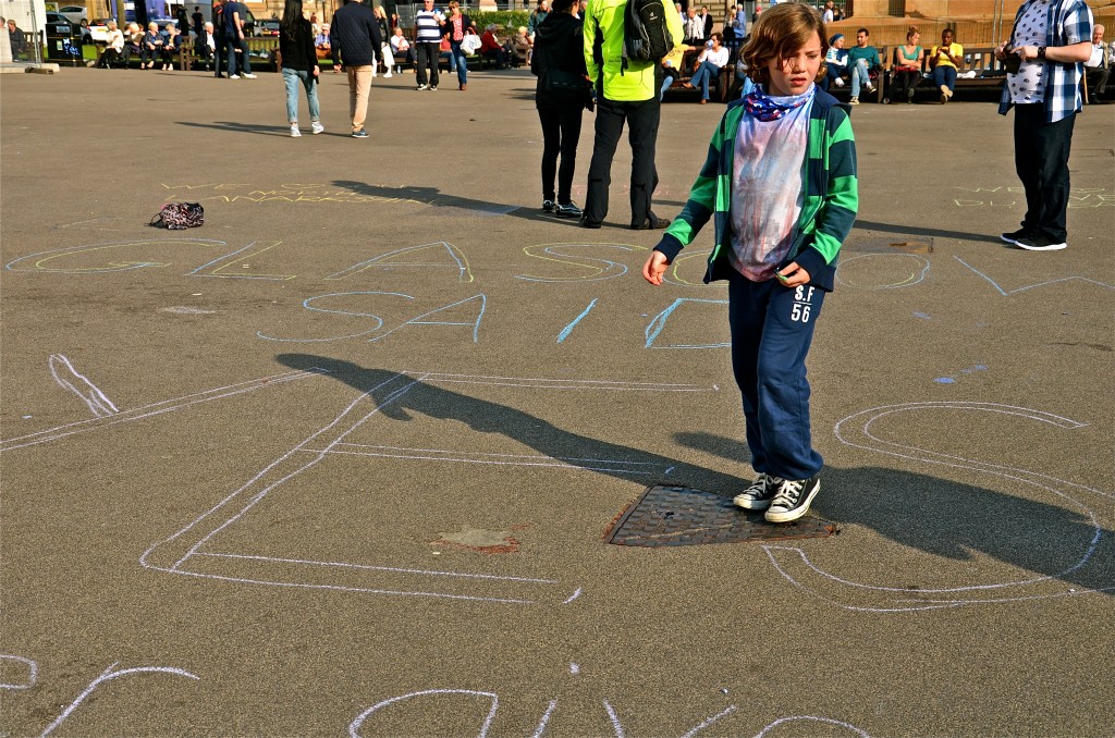 Young people chalk song lyrics on the pavings of George Square, Glasgow, after the Scottish independence referendum